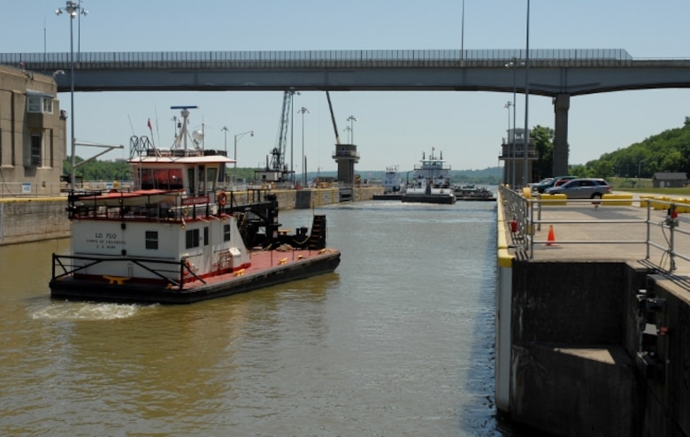 View of a U.S. Army Corps of Engineers work boat and a barge locking through at Markland Locks and Dam in Warsaw, Kentucky.