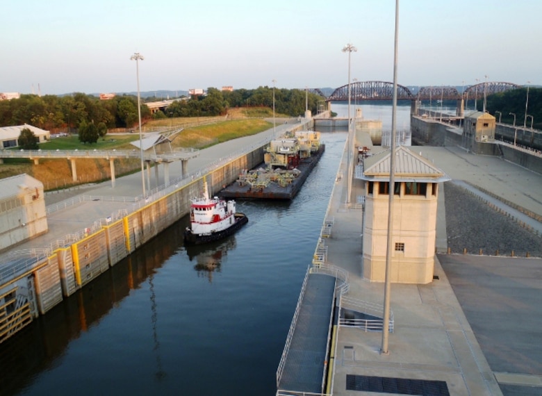 Aerial view of a tug boat and barge locking through at McAlpine Locks and Dam in Louisville, Kentucky.