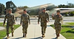 Guardians from across the U.S. Space Force, Lt. Col. Chan Shin (left) assigned to Headquarters Space Force, Lt. Col. Erica Balfour (second to left) and Maj. Joseph Gunter (second to right) assigned to U.S. Space Operations Command, walk with U.S. Air Force Lt. Col. Theresa Kopecky, 16th Air Force, U.S. Space Force liaison officer, to the 16th Air Force headquarters building at Joint Base San Antonio-Lackland, Texas, Nov. 15, 2023. 16th Air Force unifies mission support with Space Operations Command to grow readiness. Developing tactics and techniques with the information forces (Public Affairs, Information Operations forces, Electromagnetic Spectrum Operations elements, cyberspace forces) supports combat operations—a U.S. Cyber Command mission priority to maximize DoD's capabilities. (U.S. Air Force photo by Deirdre McNamara)