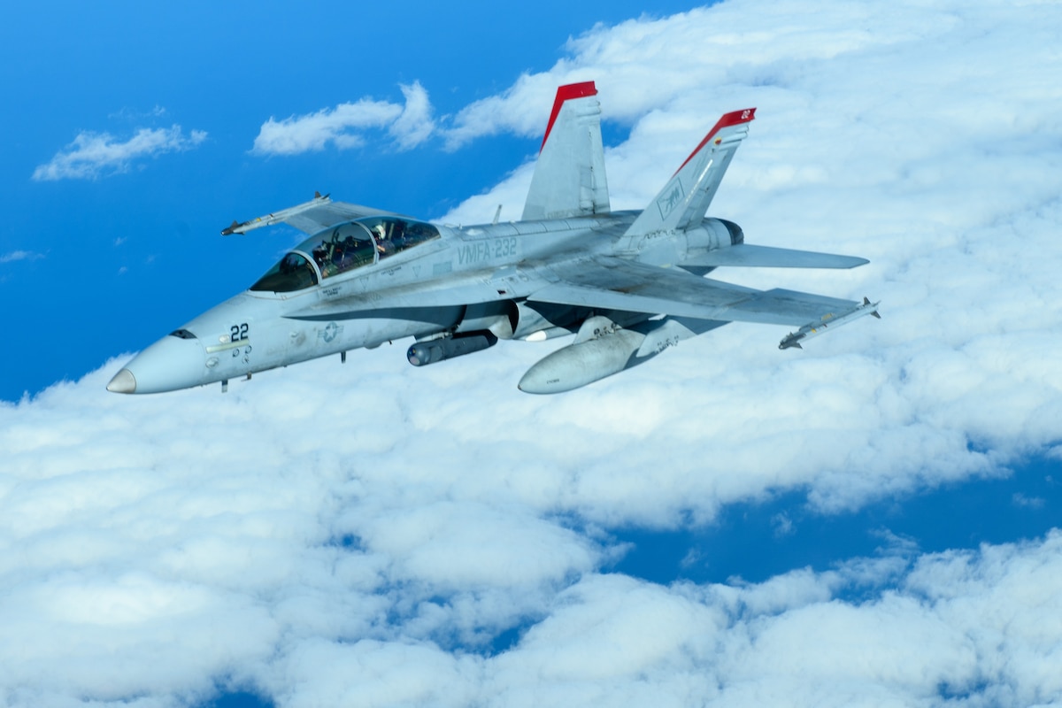 A U.S. Marine Corps F/A-18 Hornet pulls away from a U.S. Air Force KC-135 Stratotanker from Kadena Air Base after refueling over the Pacific Jan. 3, 2024. Conducting joint operations enhances the lethality and readiness of U.S. forces and its ability to project superior airpower to the Indo-Pacific region. (U.S. Air Force photo by Senior Airman Cedriue Oldaker)