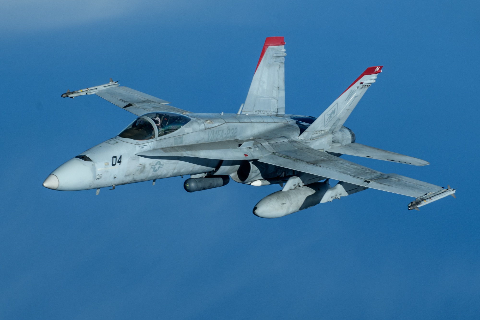 A U.S. Marine Corps F/A-18 Hornet pulls away from a U.S. Air Force KC-135 Stratotanker from Kadena Air Base after refueling over the Pacific Jan. 3, 2024. Conducting joint operations enhances the lethality and readiness of U.S. forces and its ability to project superior airpower to the Indo-Pacific region. (U.S. Air Force photo by Senior Airman Cedriue Oldaker)