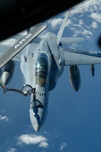 A U.S. Marine Corps F/A-18 Hornet is refueled by a U.S. Air Force KC-135 Stratotanker from Kadena Air Base over the Pacific Jan. 3, 2024. The 909th Air Refueling Squadron conducts joint operations throughout the Indo-Pacific region, demonstrating the critical role mobility forces have in projecting the joint force anywhere, anytime. (U.S. Air Force photo by Senior Airman Cedriue Oldaker)