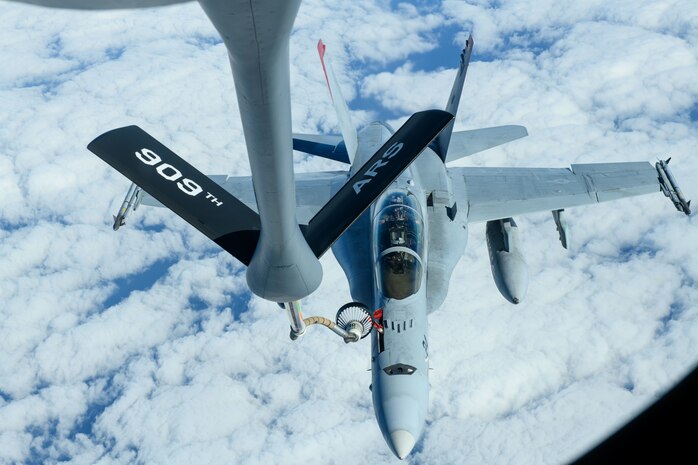 A U.S. Marine Corps F/A-18 Hornet is refueled by a U.S. Air Force KC-135 Stratotanker from Kadena Air Base over the Pacific Jan. 3, 2024. Conducting joint operations enhances the lethality and readiness of U.S. forces and its ability to project superior airpower to the Indo-Pacific region. (U.S. Air Force photo by Senior Airman Cedriue Oldaker)