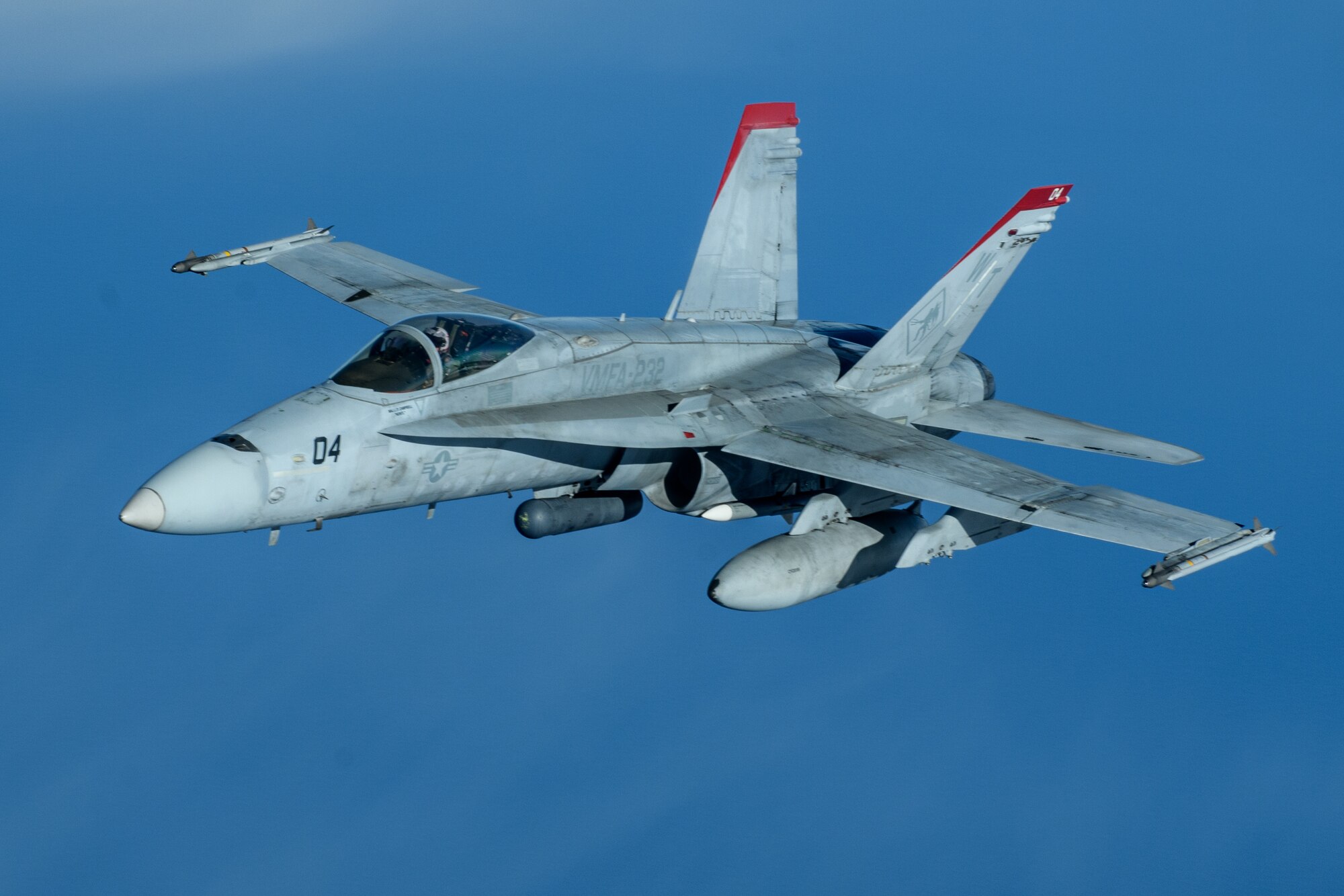 A U.S. Marine Corps F/A-18 Hornet pulls away from a U.S. Air Force KC-135 Stratotanker from Kadena Air Base after refueling over the Pacific Jan. 3, 2024. Conducting joint operations enhances the lethality and readiness of U.S. forces and its ability to project superior airpower to the Indo-Pacific region. (U.S. Air Force photo by Senior Airman Cedriue Oldaker)