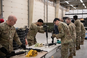 U.S. Air Force Security Forces combat arms training and maintenance specialists and civilians from across the Air Force voluntarily clean and pack weapons at Cannon Air Force Base, N.M., Nov. 28, 2023. The process began with meticulously disassembling and cleaning nearly 1,000 weapons before organizing them into extended storage.