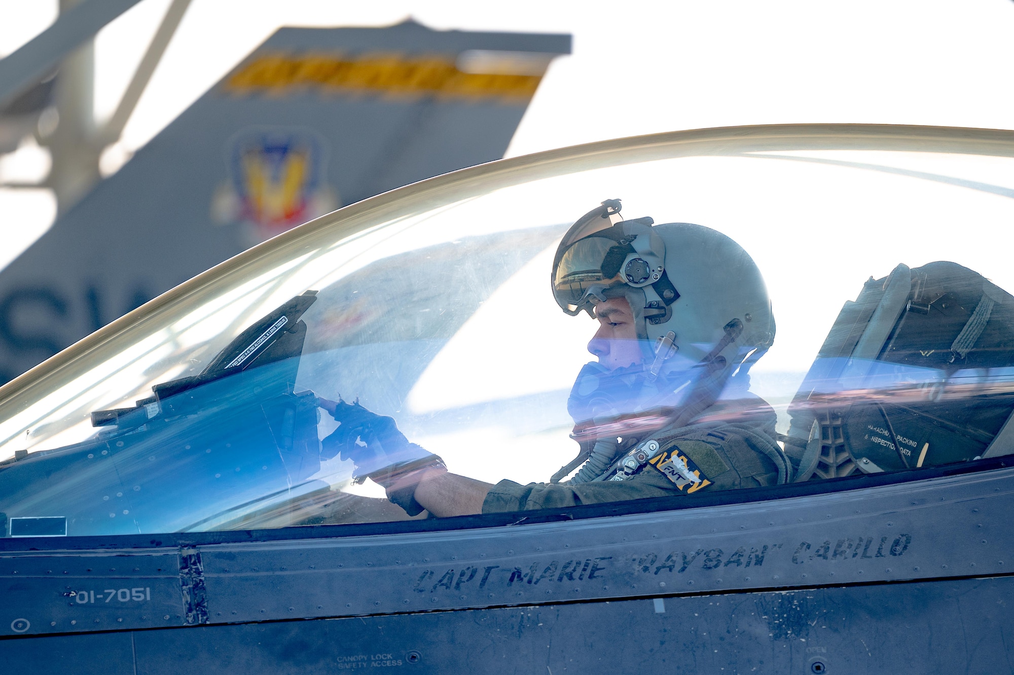A pilot performs pre-flight checks from within his aircraft.