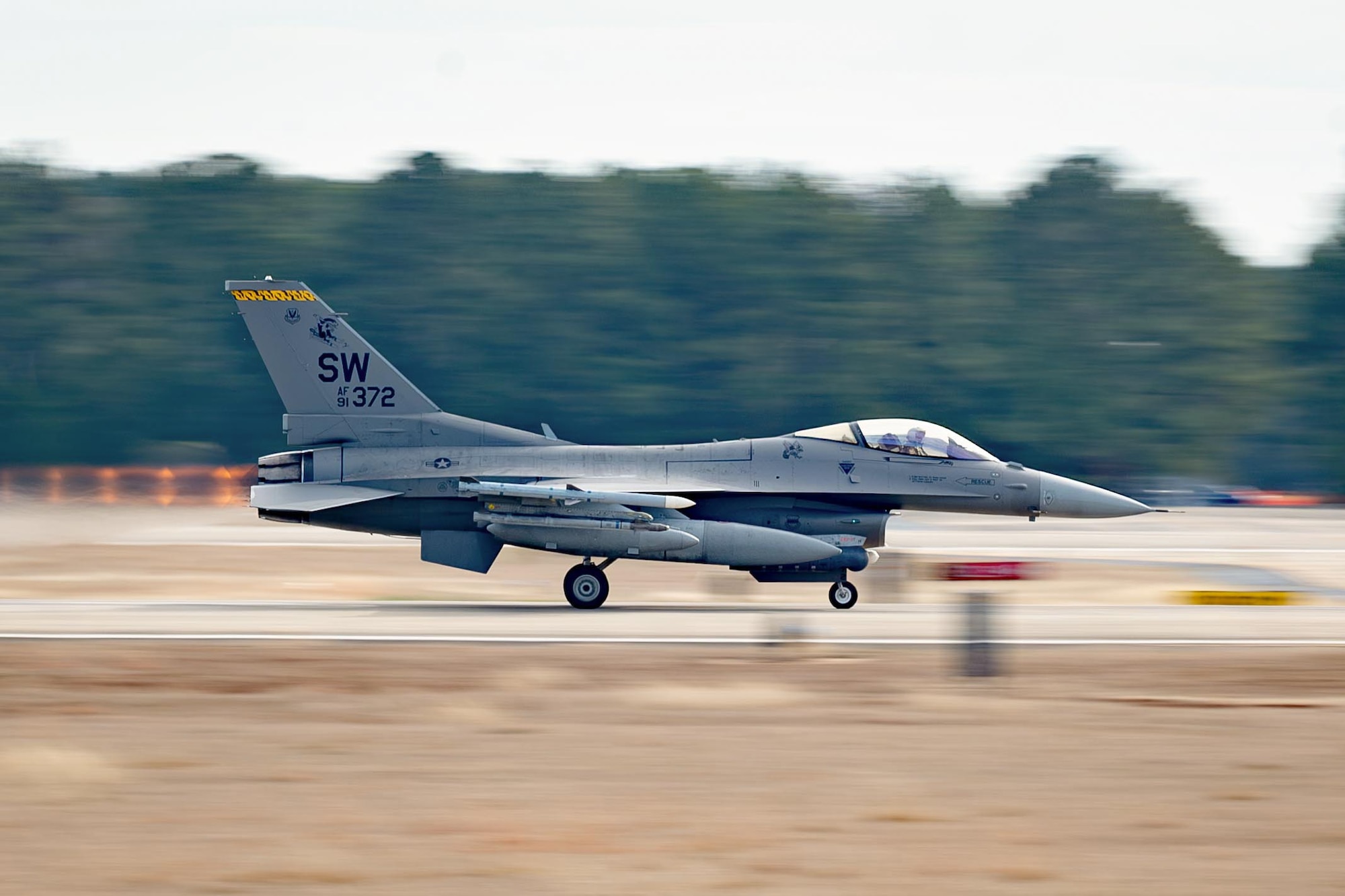 An F-16 takes off from the runway.