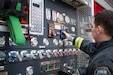 Firefighter at truck control deck.