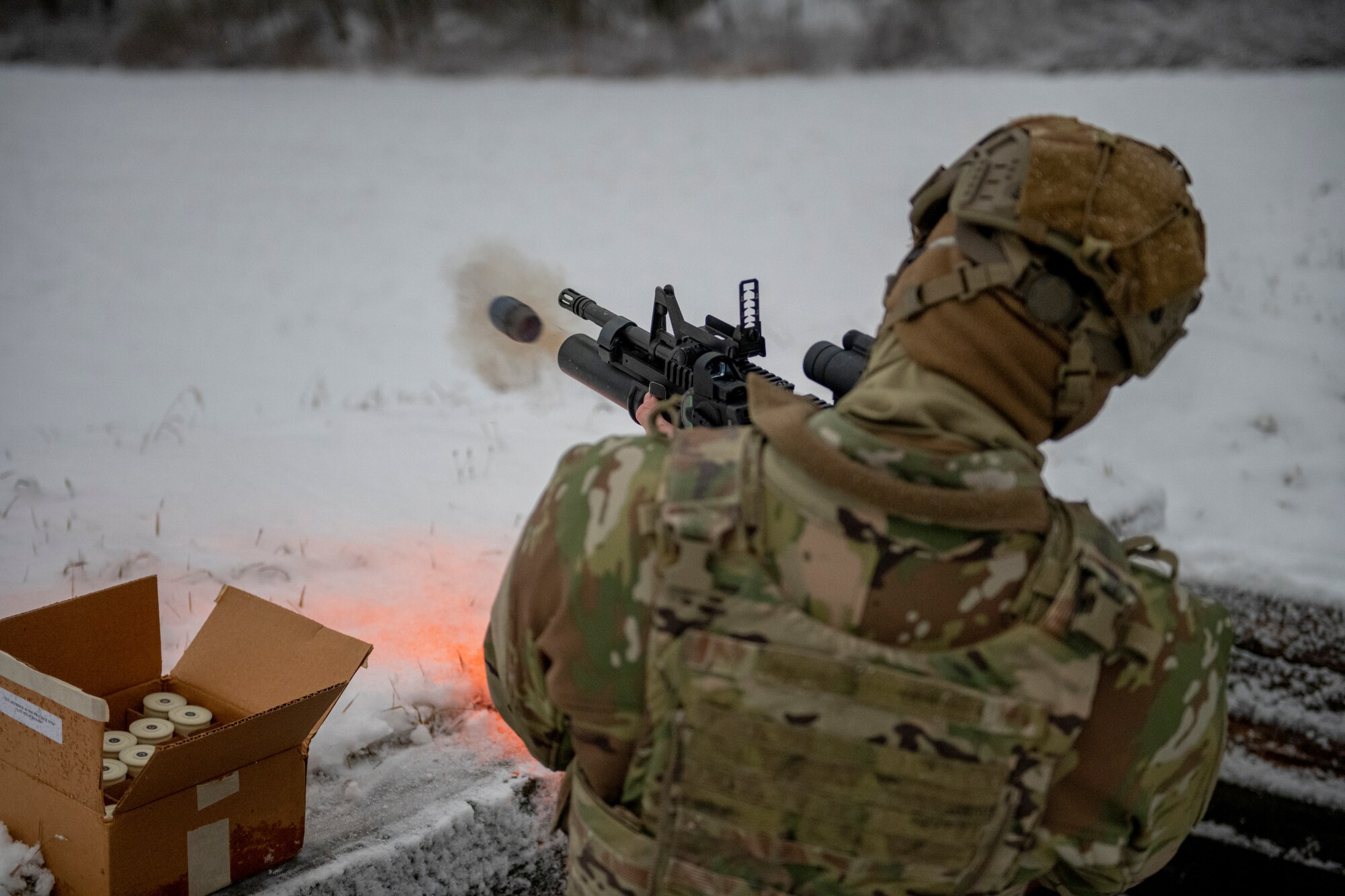 A U.S. Air Force security forces member shoots an M203 grenade launcher.