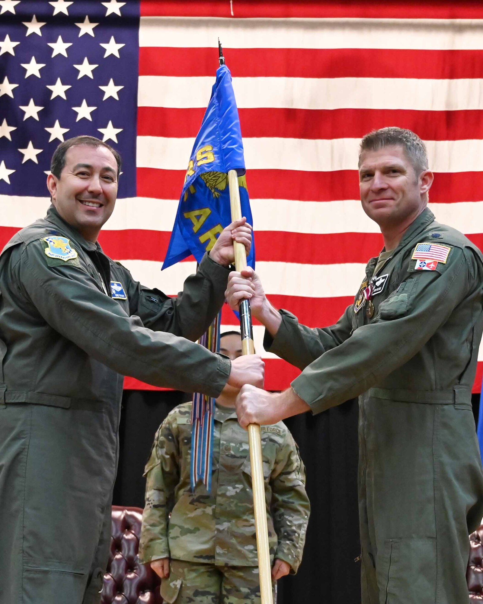 (Left to right) Col. Eric Rivero, 931st Operations Group commander hands the guidon to Lt. Col. Jason Helmick, incoming 905th Air Refueling Squadron commander, Jan. 6, 2024, McConnell Air Force Base, Kansas.