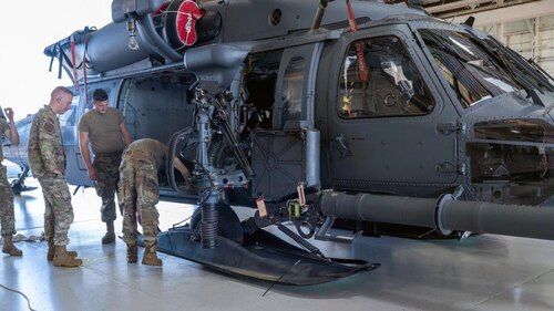 Airmen working on helicopter
