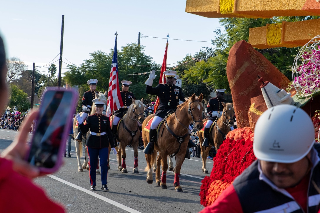 U.S. Marine Corps' Mounted Color Guard carries the American Flag and the Marine Corps Standard in the 135th Rose Parade in Pasadena, Calif., on Jan. 1, 2024. The Rose Parade is part of an annual celebration, Tournament of Roses, that includes various floats, bands, dancers and equestrian units, and is meant to showcase the beauty of Pasadena, Calif. (U.S. Marine Corps photo by Cpl. Kristina Judy)