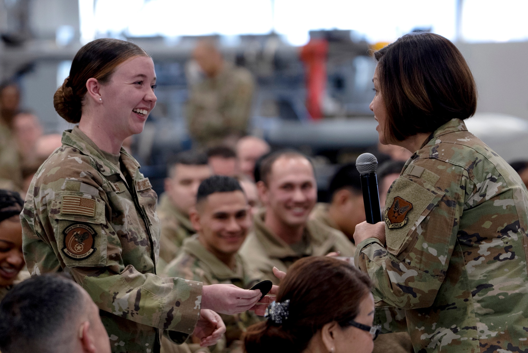 Chief Master Sgt. of the Air Force JoAnne S. Bass gives a patch to Airman 1st Class Destiny Majors