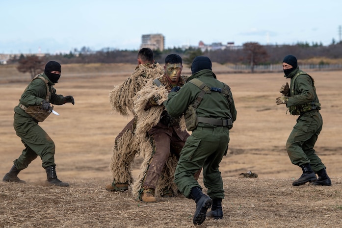 Soldiers from the Japan Ground Self-Defense Force 1st Airborne Brigade demonstrate combat techniques during the annual New Year's Jump exhibition at Camp Narashino, Japan, Jan. 7, 2024. The event served as a live demonstration of rapid insertion capabilities, highlighting the agility and readiness of airborne forces. (U.S. Air Force photo by Airman 1st Class Natalie Doan)