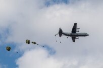 Japan Ground Self-Defense Force (JGSDF) paratroopers from the 1st Airborne Brigade (AB) jump out of a U.S. Air Force C-130J Super Hercules assigned to the 36th Airlift Squadron during the annual New Year's Jump exhibition at Camp Narashino, Japan, Jan. 7, 2024. Hosted by the JGSDF 1st AB, the event showcased the prowess of airborne forces, fostering interoperability and shared understanding within the joint airborne community. (U.S. Air Force photo by Airman 1st Class Natalie Doan)