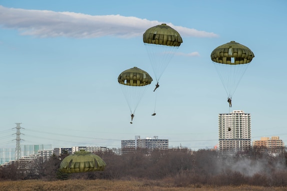 Japan Ground Self-Defense Force paratroopers from the 1st Airborne Brigade descend to a drop zone during the annual New Year's Jump exhibition at Camp Narashino, Japan, Jan. 7, 2024. The New Year's Jump not only brought together U.S. and Japanese forces, but also created a platform for international allies and partners to collaborate. (U.S. Air Force photo by Airman 1st Class Natalie Doan)