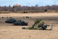 A soldier from the Japan Ground Self-Defense Force 1st Airborne Brigade aims at his target during the annual New Year's Jump exhibition at Camp Narashino, Japan, Jan. 7, 2024. With a focus on the Indo-Pacific region, the New Year's Jump underscored the preparedness of airborne forces for any mission that may arise. (U.S. Air Force photo by Airman 1st Class Natalie Doan)