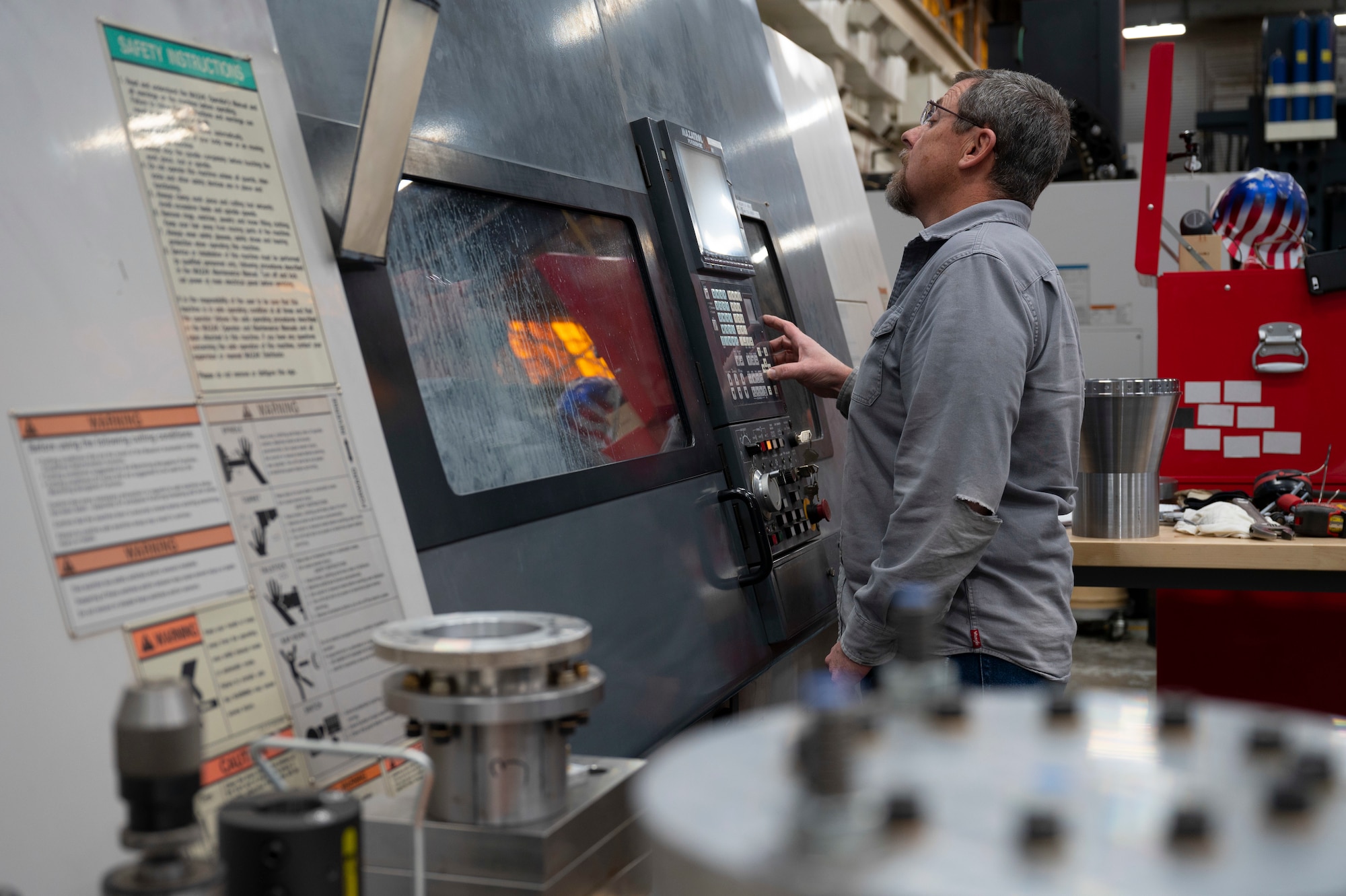 Tim Turnbull, 846th Test Squadron model maker, operates a lathe machine at Holloman Air Force Base, New Mexico, Jan. 10, 2024. The lathe is used to help assemble materials needed for the 846th TS, safety testing and weapons utilized by the Department of Defense. (U.S. Air Force photo by Airman 1st Class Michelle Ferrari)
