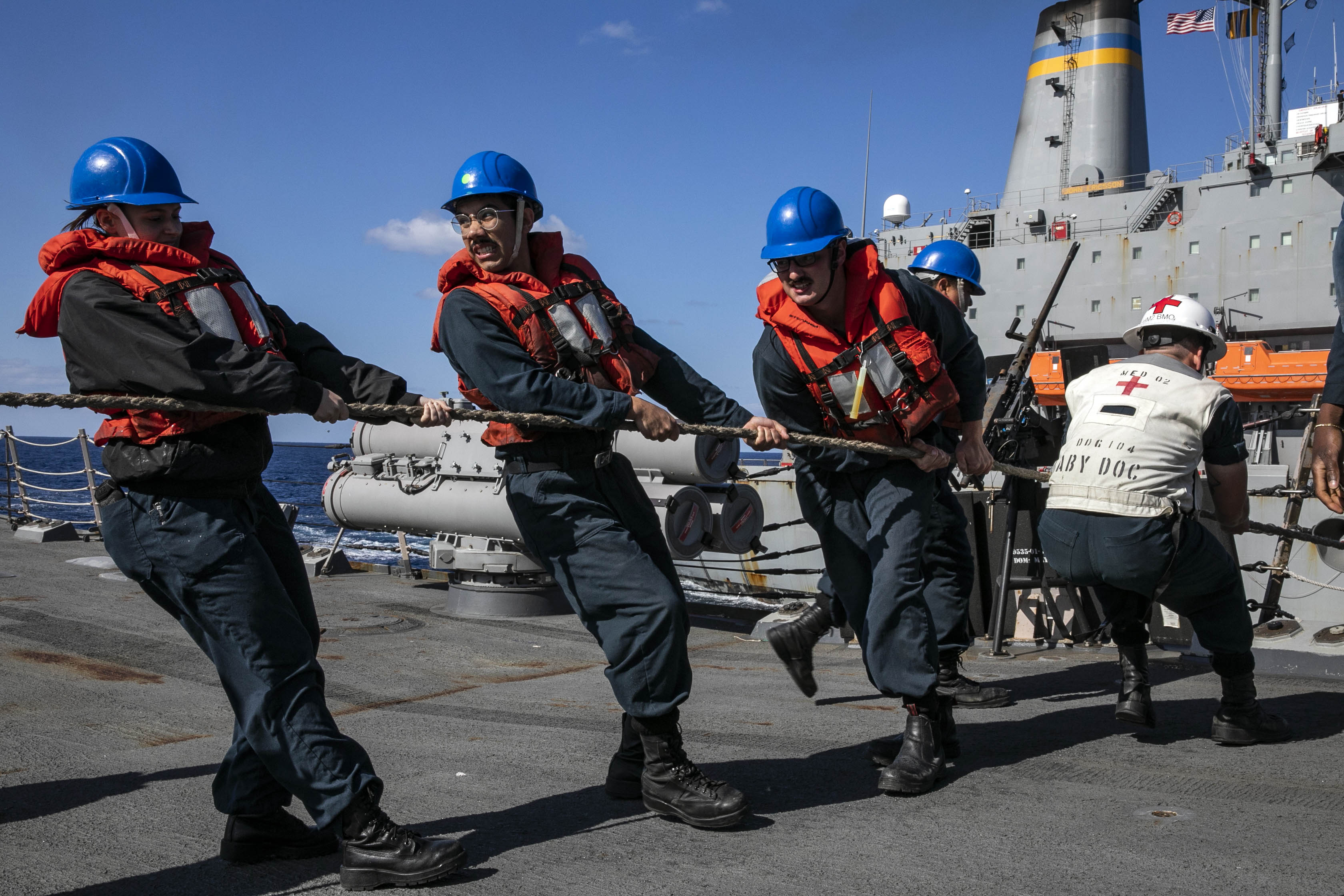Sailors aboard Arleigh Burke-class guided-missile destroyer USS Sterett (DDG 104) heave a messenger line during a replenishment-at-sea with Military Sealift Command fleet replenishment oiler USNS John Ericsson (T-AO 194).