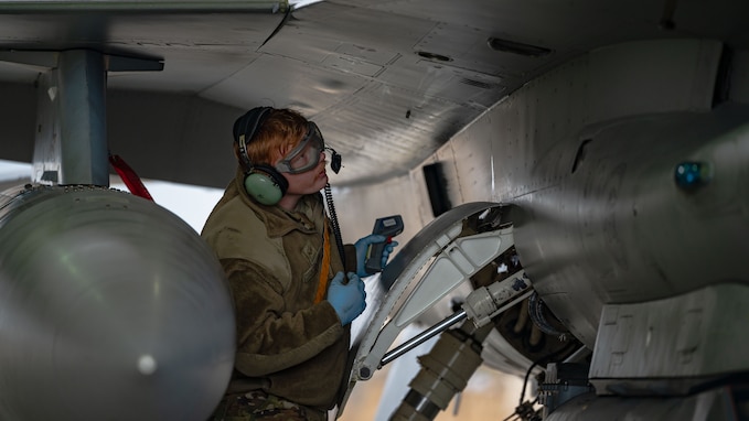 Senior Airman Collin Johnson performs maintenance procedures on an F-16.