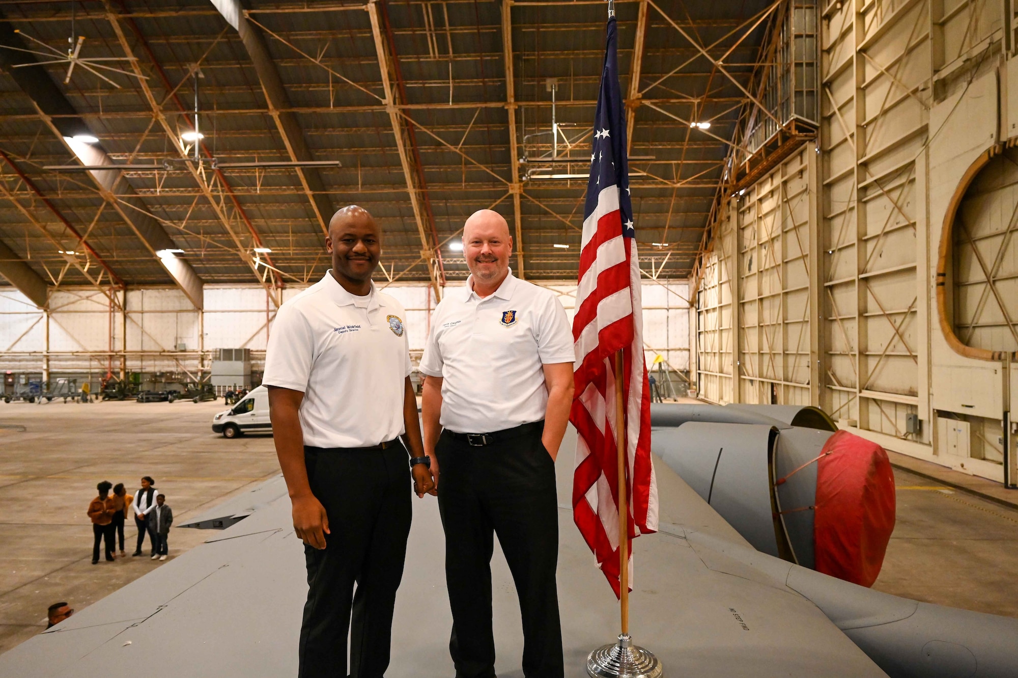 Jimmel Winkfield, left, 97th Aircraft Maintenance Squadron deputy director, poses with Travis Coughlin, 97th Maintenance Group deputy director, on the wing of a KC-135 Stratotanker at Altus Air Force Base, Oklahoma, Dec. 28, 2023. Coughlin counts it as a point of pride that he has administered the oath of enlistment to several Airmen who have moved from enlisted to officer. (U.S. Air Force photo by Airman 1st Class Kari Degraffenreed)