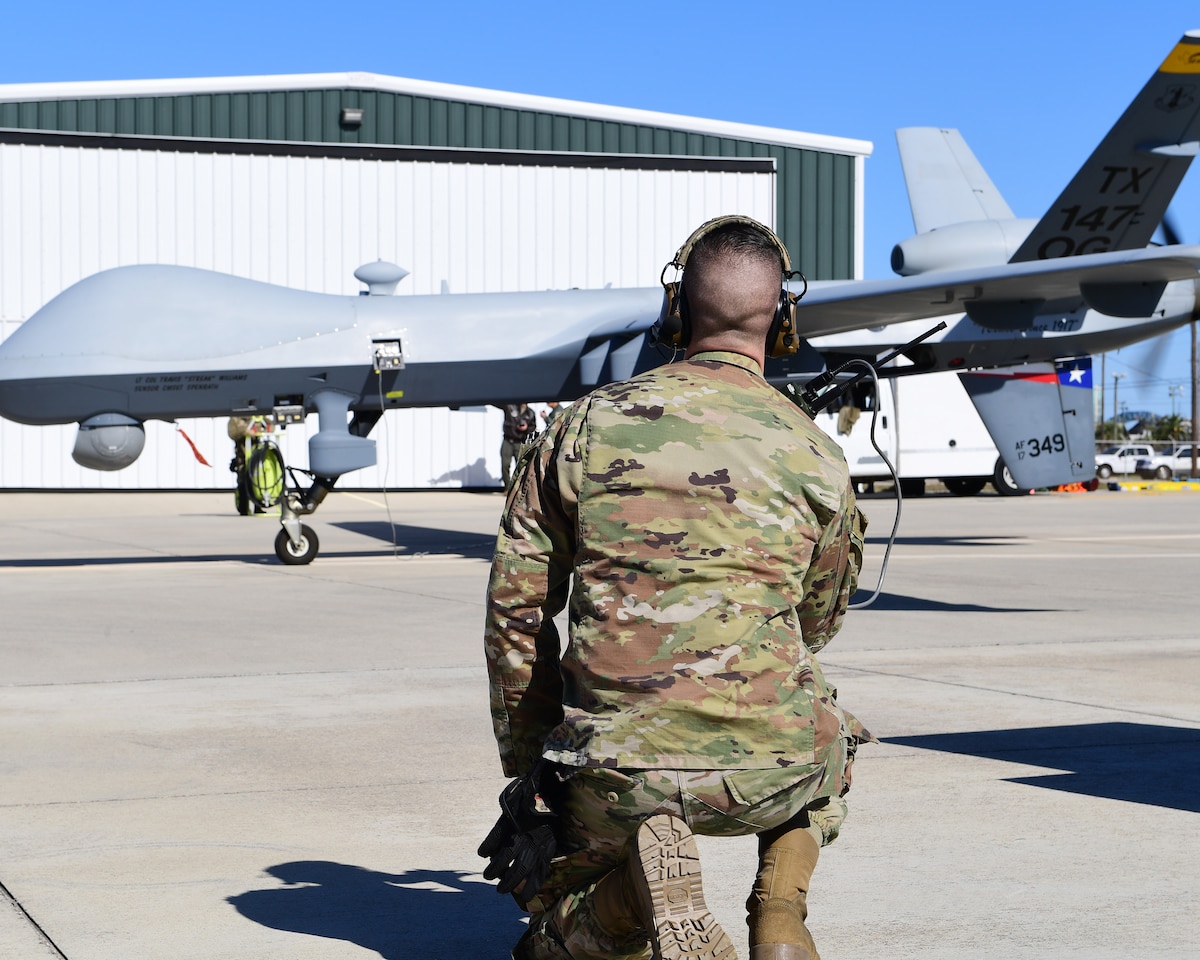 A Texas Air National Guard member of the 147th Attack Wing Aircraft Maintenance Squadron watches as an MQ-9 Reaper prepares to taxi at Scholes International Airport in Galveston, Texas, Jan. 10, 2024. The wing tested satellite launch and recovery operations as part of its approach to the Agile Combat Employment concept.