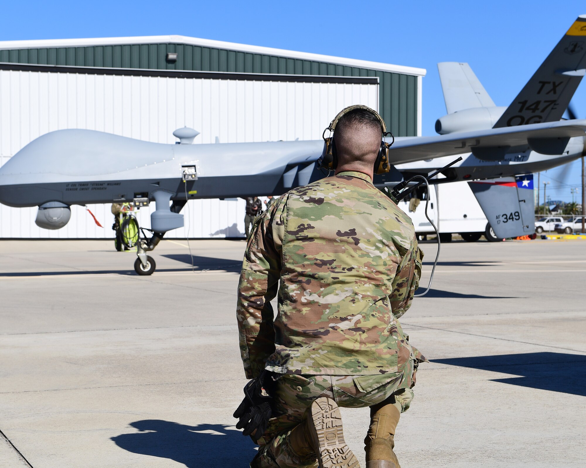 A Texas Air National Guard member of the 147th Attack Wing Aircraft Maintenance Squadron watches as an MQ-9 Reaper prepares to taxi at Scholes International Airport in Galveston, Texas, Jan. 10, 2024. The wing tested satellite launch and recovery operations as part of its approach to the Agile Combat Employment concept.