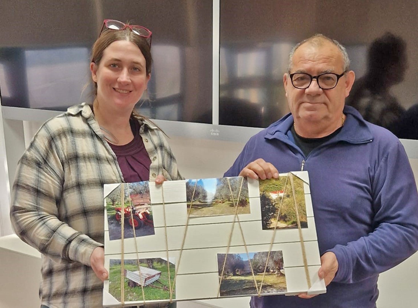 Two people pose with a memory board.
