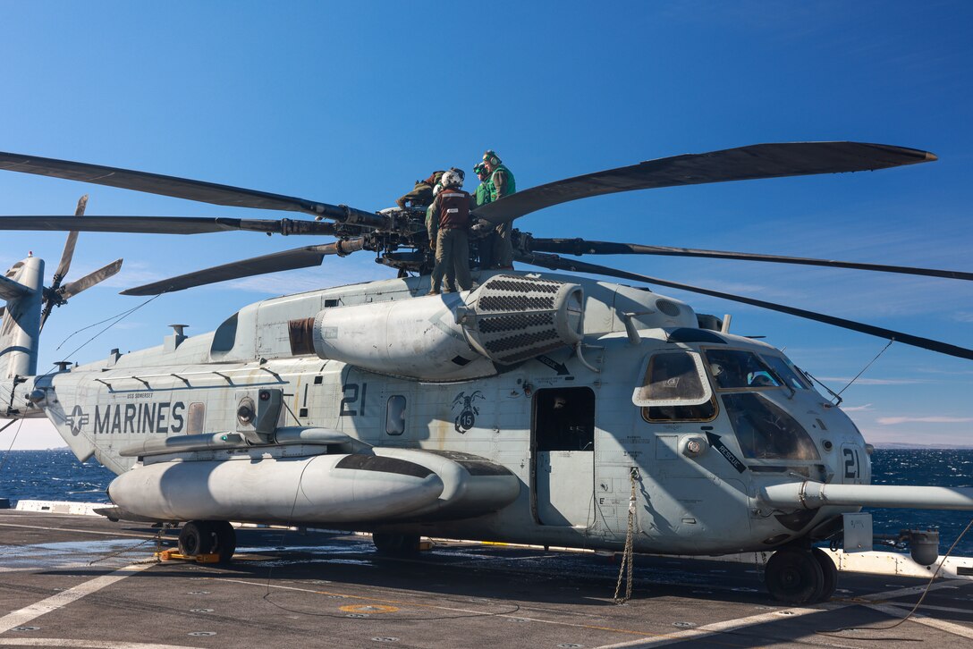 U.S. Marines assigned to Marine Medium Tiltrotor Squadron (VMM) 165 (Reinforced), 15th Marine Expeditionary Unit, conduct pre-flight inspections of a CH-53E Super Stallion aboard the amphibious transport dock USS Somerset (LPD 25) in the Pacific Ocean, Jan. 7, 2023. A helicopter support team used the Super Stallion to conduct an external lift for a resupply mission supporting an expeditionary advanced base ashore. The 15th MEU is currently embarked aboard the Boxer Amphibious Ready Group conducting integrated training and routine operations in U.S. 3rd Fleet. (U.S. Marine Corps photo by Cpl. Aidan Hekker)