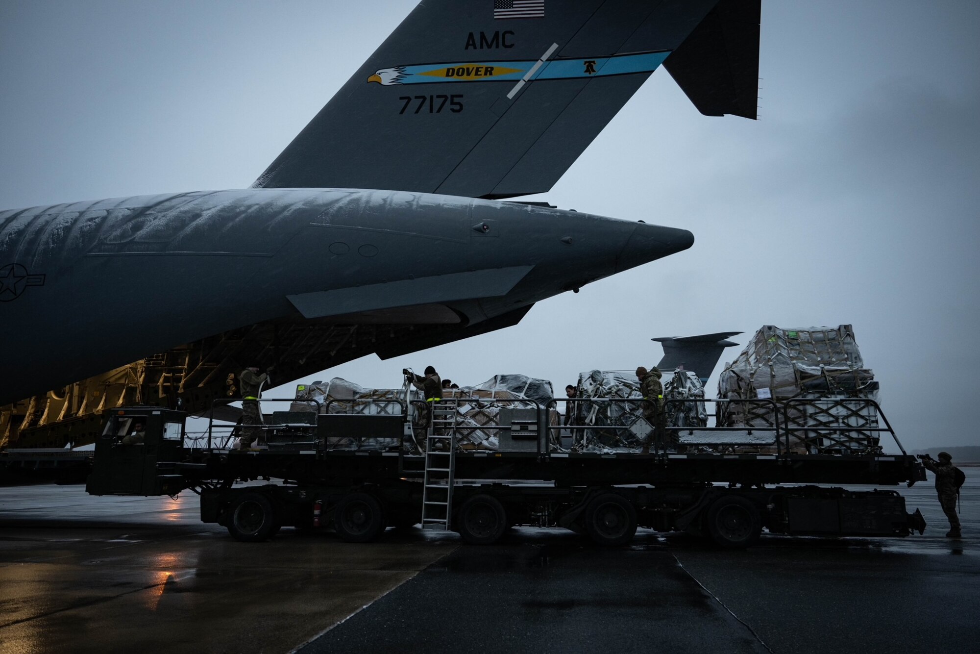 U.S. Air Force Airmen from the 436th Aerial Port Squadron, load cargo onto a C-17 Globemaster III at Dover Air Force Base, Delaware, Jan. 15, 2024. Team Dover Airmen continued to operate as normal despite freezing temperatures and snowfall from Winter Storm Heather. (U.S. Air Force photo by Staff Sgt. Marco Gomez)