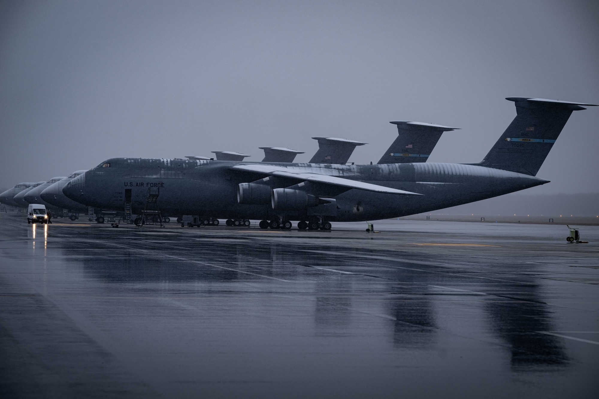Snow-covered C-5M Super Galaxies sit on the flight line at Dover Air Force Base, Delaware, Jan. 15, 2024. Team Dover Airmen continued to operate as normal despite freezing temperatures and snowfall from Winter Storm Heather. (U.S. Air Force photo by Staff Sgt. Marco Gomez)