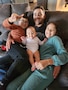 Man sits on couch with his two sons and daughter