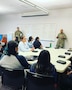 Two male U.S. Army Soldiers in uniform give a lecture to a class