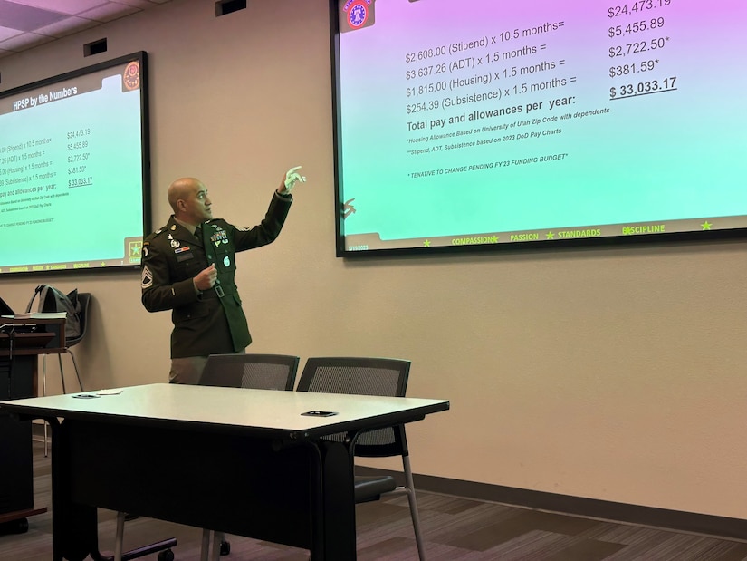 Male U.S. Army Soldier in dress uniform gives a power point presentation