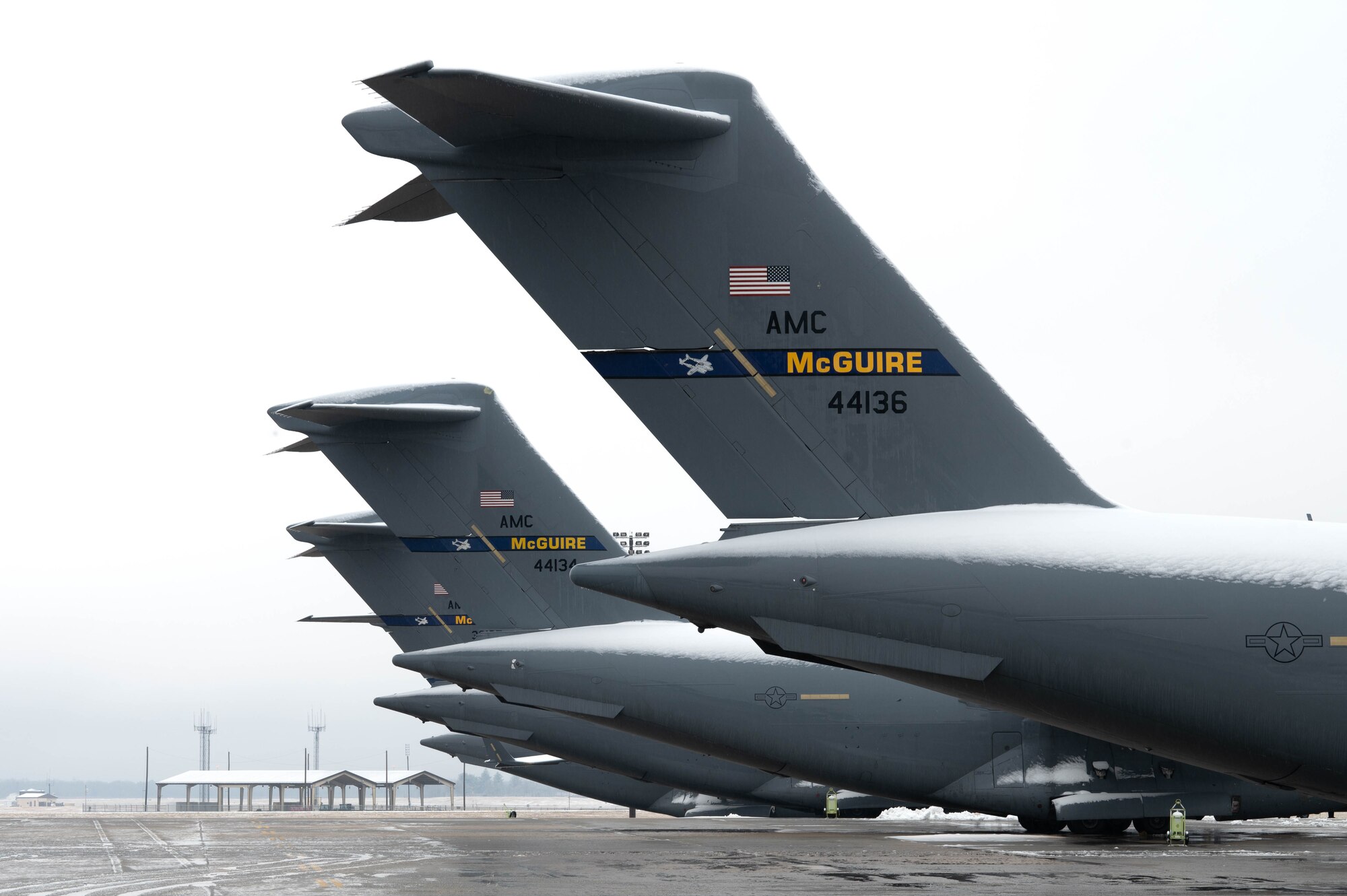 C-17 Globemaster IIIs assigned to the 305th Air Mobility Wing park on the flightline during a winter storm at Joint Base McGuire-Dix-Lakehurst, N.J., Jan. 16, 2024. U.S. Air Force Airmen assigned to JB MDL maneuvered through harsh conditions to keep the mission going despite several base closures due to safety concerns. (U.S. Air Force photo by Airman 1st Class Aidan Thompson)