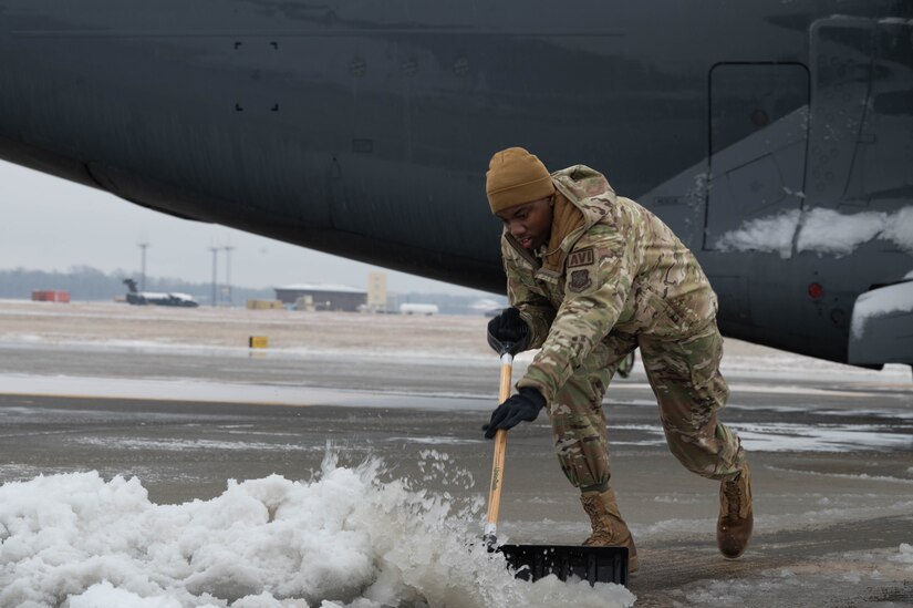 A U.S. Air Force Airman assigned to the 305th Air Mobility Wing shovels snow on the flightline during a winter storm at Joint Base McGuire-Dix-Lakehurst, N.J., Jan. 16, 2024. Airmen assigned to various JB MDL squadrons maneuvered through harsh conditions to keep the mission going despite several base closures due to safety concerns. (U.S. Air Force photo by Airman 1st Class Aidan Thompson)