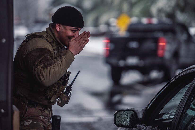 A U.S. Air Force Airman assigned to the 87th Security Forces Squadron renders a salute while manning a gate entrance during a winter storm at Joint Base McGuire-Dix-Lakehurst, N.J., Jan. 16, 2024. Airmen assigned to various JB MDL squadrons maneuvered through harsh conditions to keep the mission going despite several base closures due to safety concerns. (U.S. Air Force photo by Staff Sgt. Austin Knox)