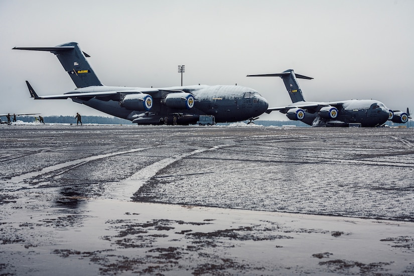 C-17 Globemaster IIIs assigned to the 305th Air Mobility Wing park on the flightline during a winter storm at Joint Base McGuire-Dix-Lakehurst, N.J., Jan. 16, 2024. U.S. Air Force Airmen assigned to JB MDL maneuvered through harsh conditions to keep the mission going despite several base closures due to safety concerns. (U.S. Air Force photo by Staff Sgt. Austin Knox)