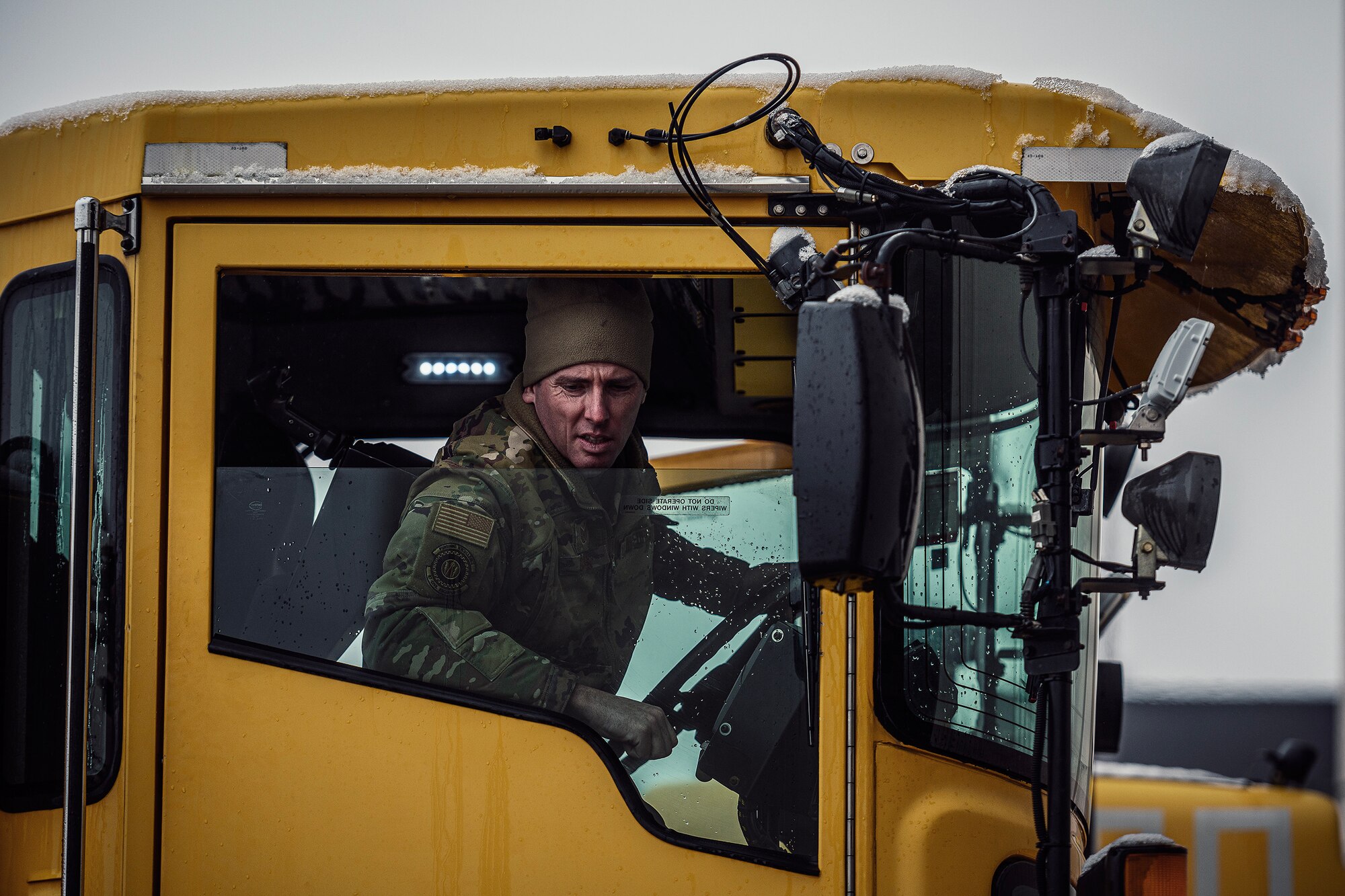 A U.S. Air Force Airman assigned to the 305th Air Mobility Wing operates a snow-removal vehicle during a winter storm at Joint Base McGuire-Dix-Lakehurst, N.J., Jan. 16, 2024. Airmen assigned to various JB MDL squadrons maneuvered through harsh conditions to keep the mission going despite several base closures due to safety concerns. (U.S. Air Force photo by Staff Sgt. Austin Knox)