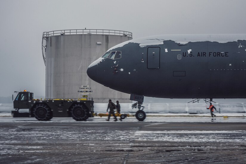 U.S. Air Force Airmen assigned to the 305th Air Mobility Wing clear the flightline of snow during a winter storm at Joint Base McGuire-Dix-Lakehurst, N.J., Jan. 16, 2024. Airmen assigned to various JB MDL squadrons maneuvered through harsh conditions to keep the mission going despite several base closures due to safety concerns. (U.S. Air Force photo by Staff Sgt. Austin Knox)