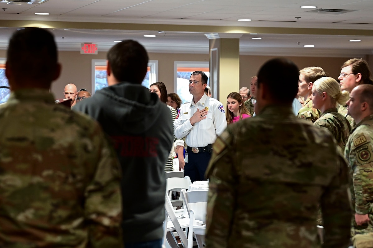 Patrick Brody, 17th Training Wing honorary commander, along with members of the 17th Training Group stand during the National Anthem while attending the 17th Training Group annual awards ceremony at the San Angelo Country Club, San Angelo, Texas, Jan. 12, 2024. The honorary commanders started their day off with the opportunity to interact and have breakfast with members of the 17th TRG. (U.S. Air Force photo by Airman 1st Class Madison Collier)