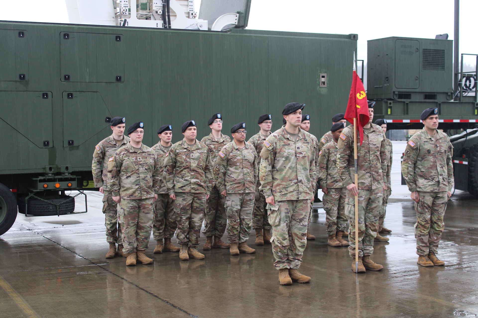 U.S. Army Soldiers from Delta Battery, 5th Battalion, 3rd Field Artillery Regiment, 1st Multi-Domain Task Force stand in formation behind a Mid-Range Capability (MRC) Launcher at Joint Base Lewis-McChord, Washington, January 10, 2024.