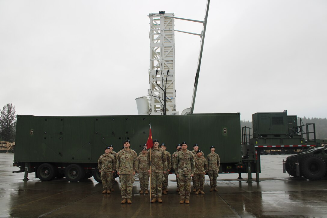 U.S. Army Soldiers from Delta Battery, 5th Battalion, 3rd Field Artillery Regiment, 1st Multi-Domain Task Force stand in formation behind a Mid-Range Capability (MRC) Launcher at Joint Base Lewis-McChord, Washington, January 10, 2024.