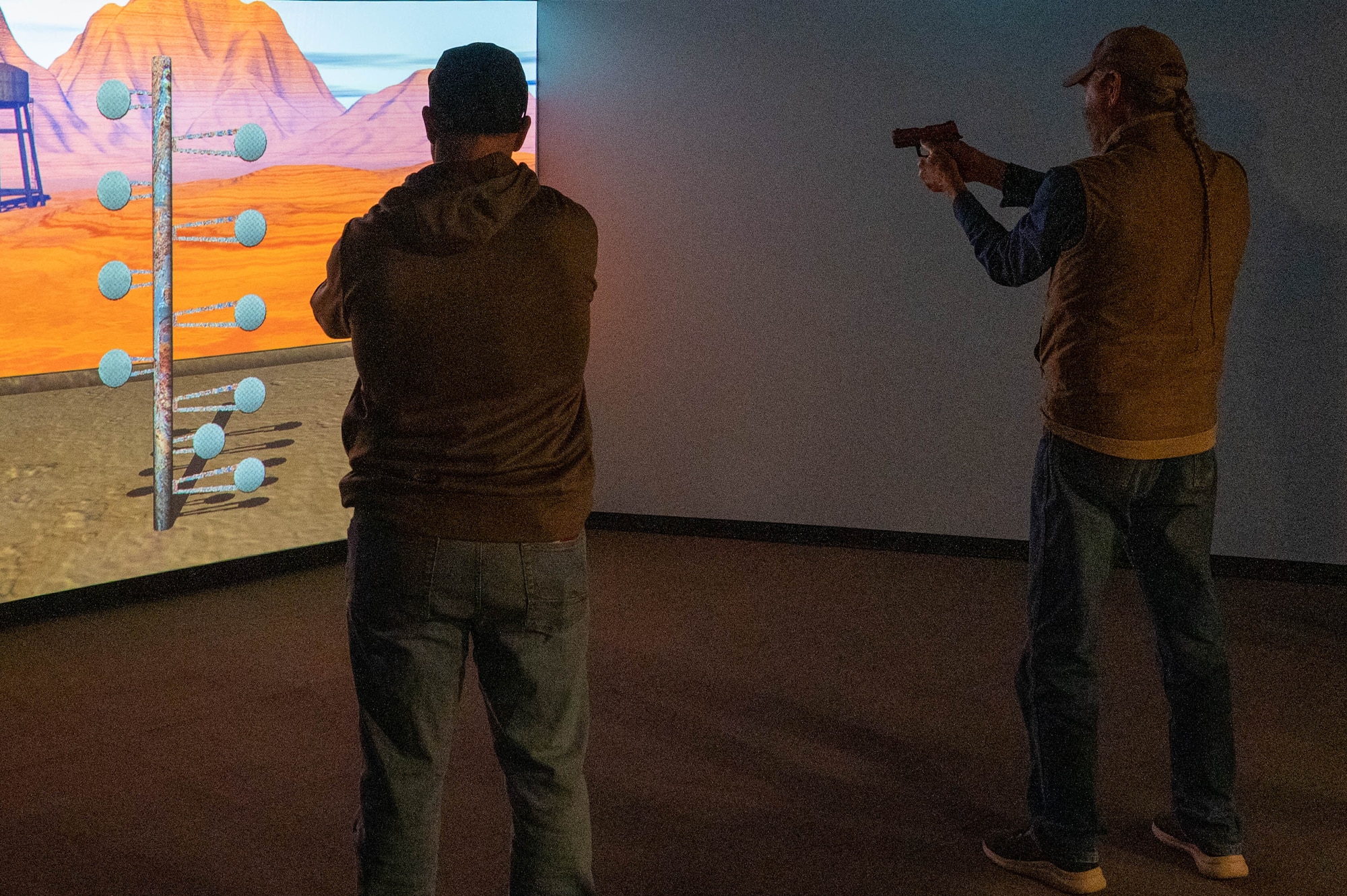 Tom Buchanan (right), Lugert-Altus Irrigation district manager, participates in a 3-D virtual shooting exercise during the Air Power and Agriculture: Base Tour at Altus Air Force Base, Oklahoma, Jan. 12, 2024. Buchanan was appointed as a Friend of Altus and has been assisting the Airpower and Agriculture tours for several years. (U.S. Air Force photo by Airman First Class Heidi Bucins)