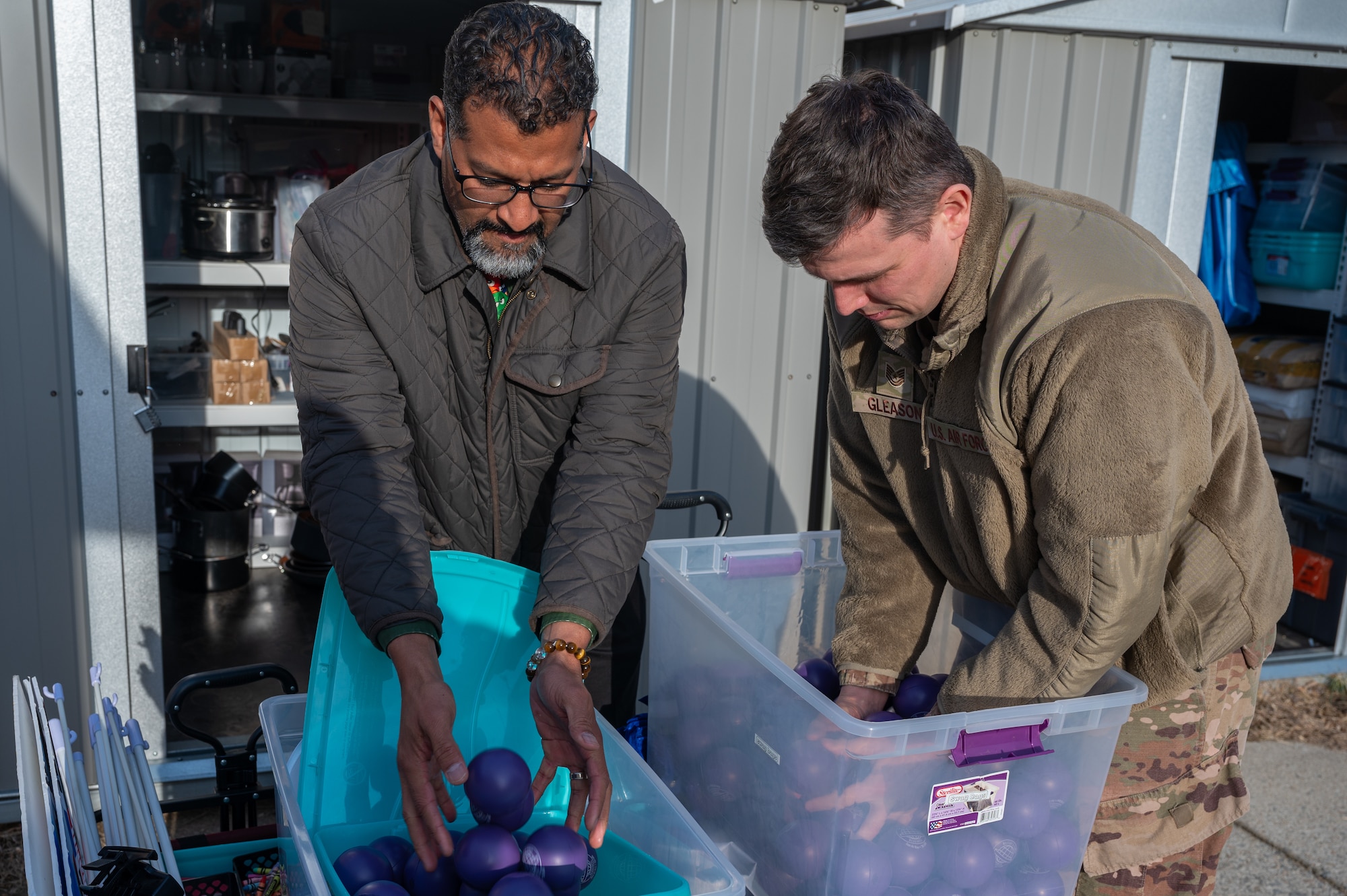 Hilario Marte-Sanchez, 51st Fighter Wing Military and Family Readiness Center community readiness consultant, left, and U.S. Air Force Tech. Sgt. Timothy Gleason, M&FRC noncombatant evacuation operations noncommissioned officer in charge, gather handouts for a newcomers briefing at Osan Air Base, Republic of Korea, Jan. 16, 2024. The NEO section of the M&FRC ensures that any noncombatant, including the families of Airmen, pets and any additional noncombatants at Osan, are accounted for and can be evacuated safely from the area in the event of a contingency. (U.S. Air Force photo by Airman 1st Class Chase Verzaal)