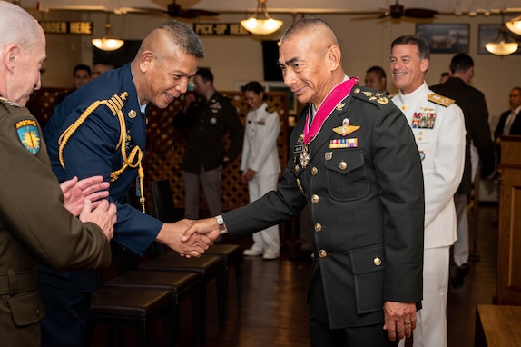 Thai and U.S. military members congratulate Gen. Chalermphon Srisawasdi, former Royal Thai Armed Forces (RTARF) Chief of Defence, after he received the Legion of Merit pinned by Adm. John C. Aquilino, Commander of U.S. Indo-Pacific Command, in Bangkok on Jan. 18, 2024. The Legion of Merit is the highest accolade that the U.S. can bestow upon a foreign leader; it is reserved for individuals who have shown exceptionally meritorious conduct in the performance of outstanding services. USINDOPACOM is committed to enhancing stability in the Indo-Pacific region by promoting security cooperation, encouraging peaceful development, responding to contingencies, deterring aggression and, when necessary, fighting to win. (U.S. Navy photo by Chief Mass Communication Specialist Shannon M. Smith)
