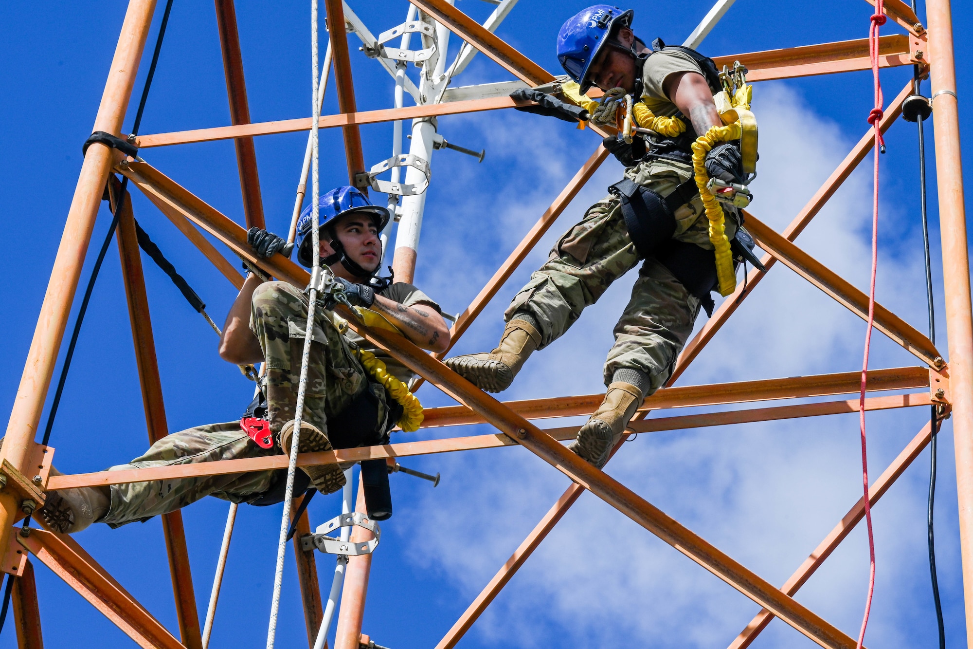 Staff Sgt. James Fearney, and Airman Tavake Marquez, 747th Cyber Security Squadron expeditionary communications specialists, complete a climbing certification class at Joint Base PEarl Harbor-Hickam, Hawaii, Jan. 11, 2024. Cyber airmen conduct routine maintenance to the towers supporting the Joint Base and are responsible for keeping the Internet and phone communications running. (U.S. Air Force photo by Senior Airman Makensie Cooper)