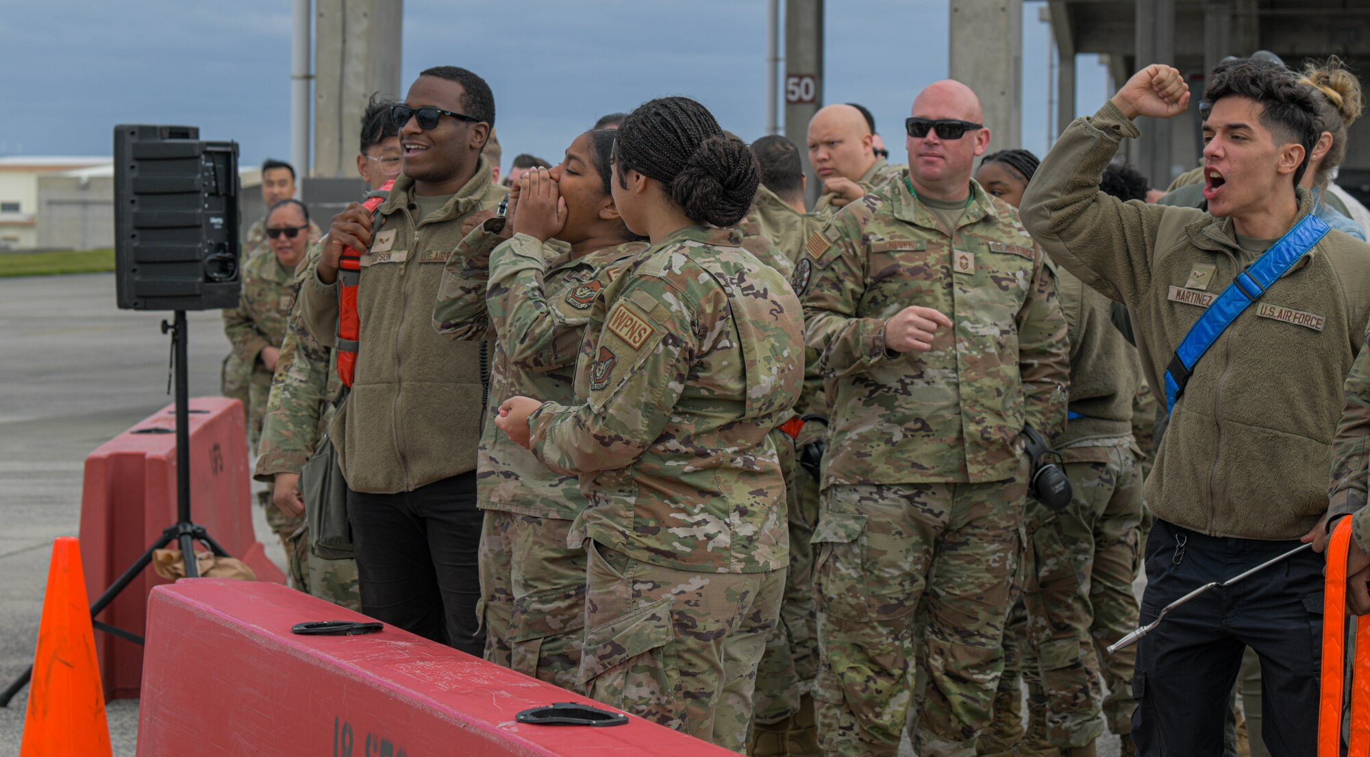 airmen crowded together to watch competition