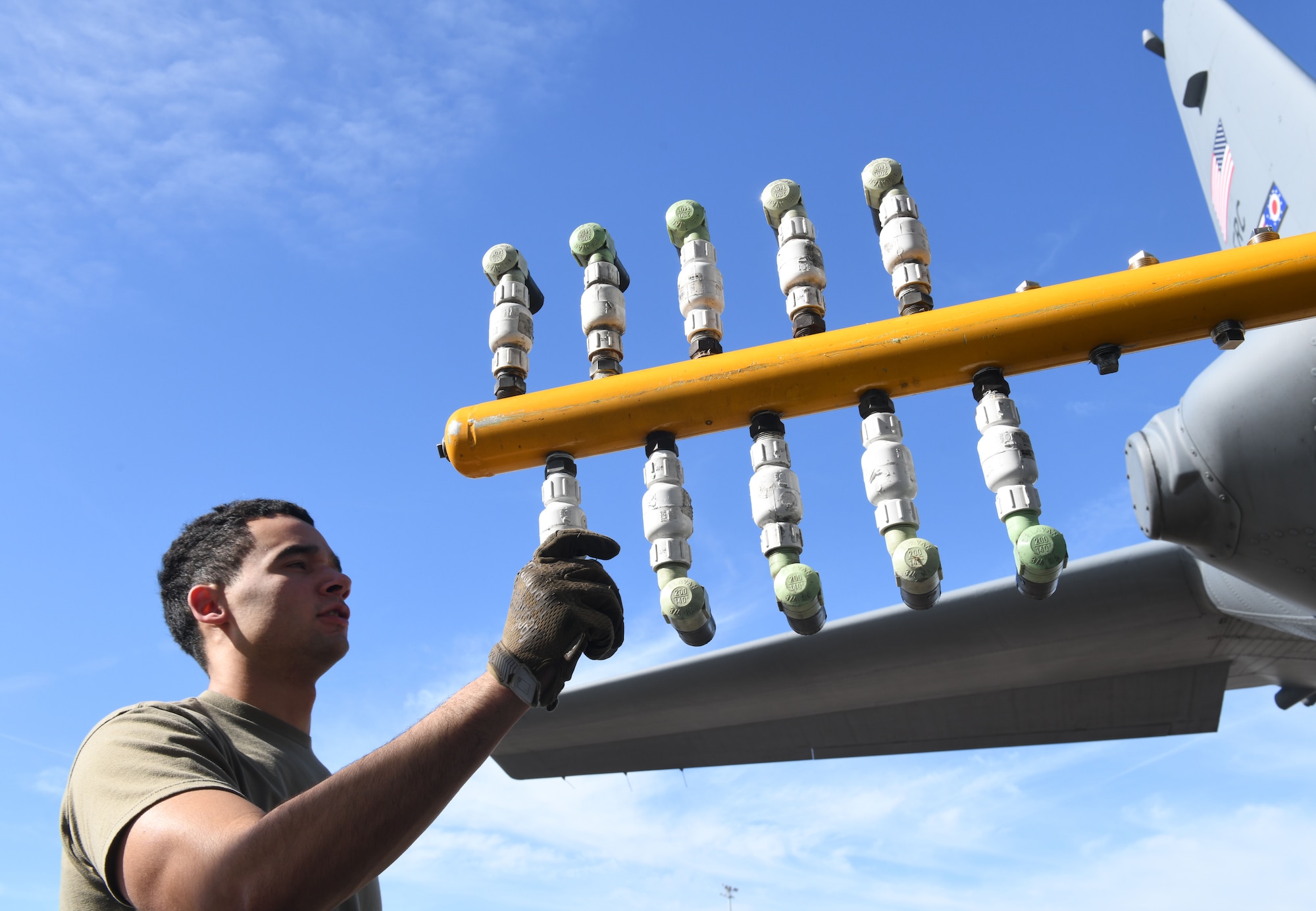 Staff Sgt. Bryce Cooper, aerial spray technician assigned to the 757th Airlift Squadron, readies the 910th Airlift Wing’s modular aerial system, Jan. 7, 2024, for a C-130H Hercules aerial spray demonstration at the Manatee County Regional Airport, Florida.