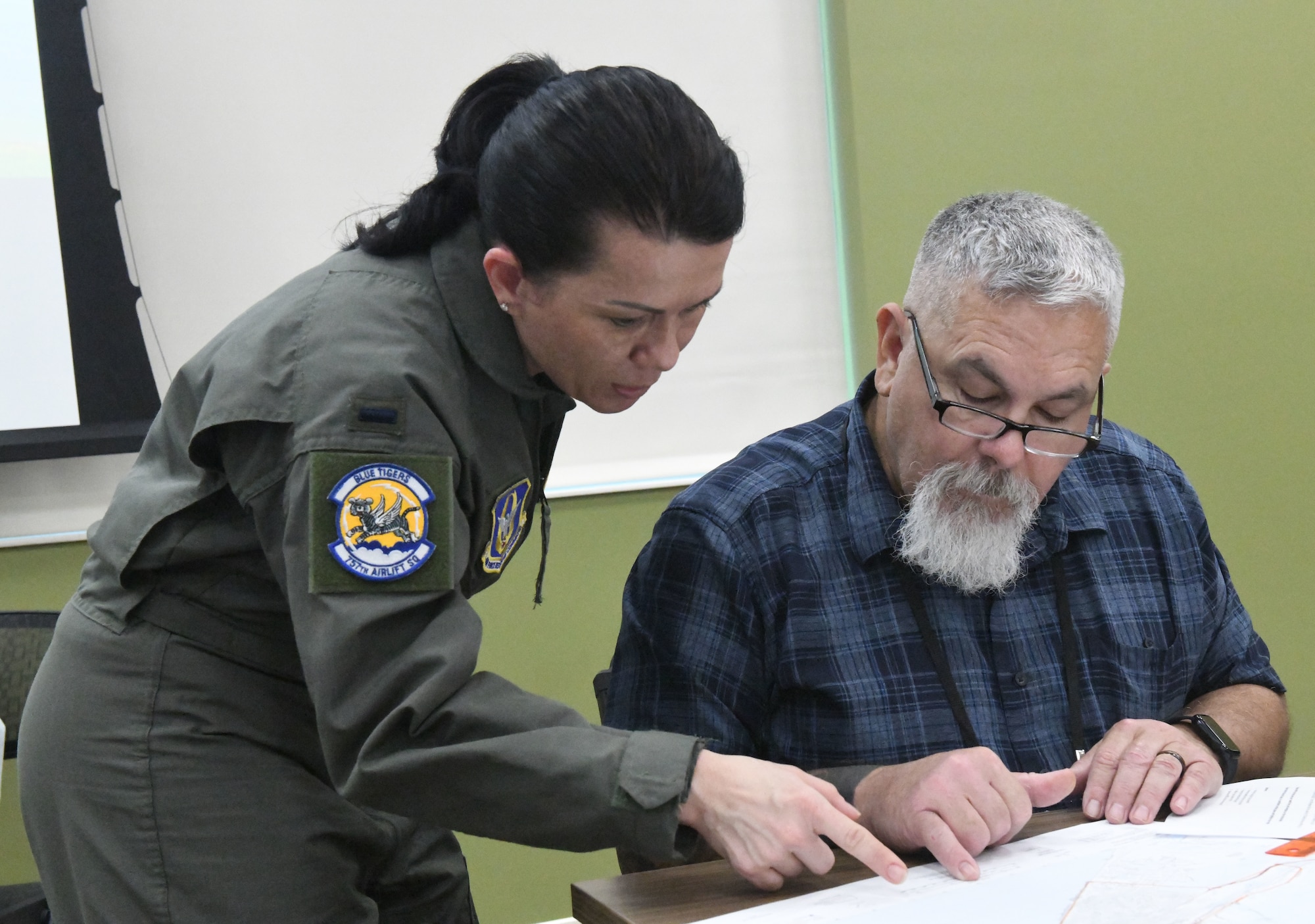 First Lt. Bethany Eutsey, a medical entomologist assigned to the 757th Airlift Squadron, assists a course attendee with mapping in preparation for the aerial spray demonstration as part of the Department of Defense Aerial Spray Category 11 Applicator Course at Manatee County Mosquito Control District’s Headquarters, Florida, from Jan. 8-11, 2024.
